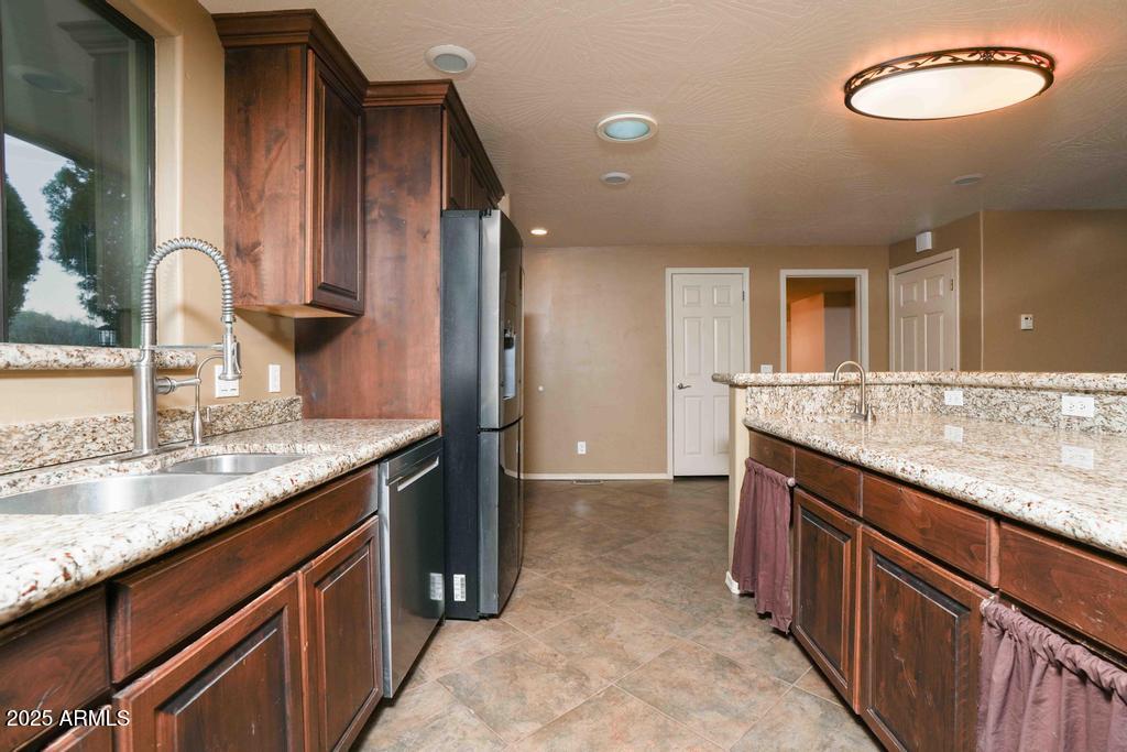 4330 East Navajo Lane Rimrock, AZ 86335 - Photo 19 of 59 a kitchen with stainless steel appliances granite countertop a sink and a stove