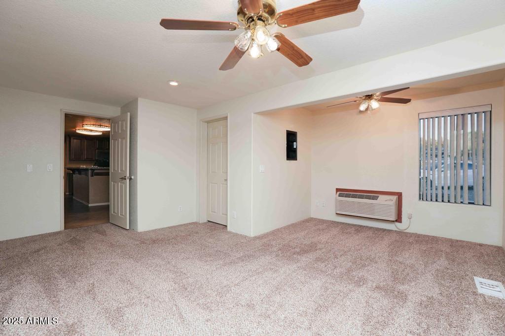 4330 East Navajo Lane Rimrock, AZ 86335 - Photo 28 of 59 an empty room with chandelier fan and windows