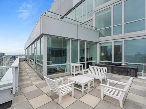 2 2nd Street, Unit 4001 Jersey City, NJ 07302 - Photo 9 of 31 a roof deck with a table and chairs