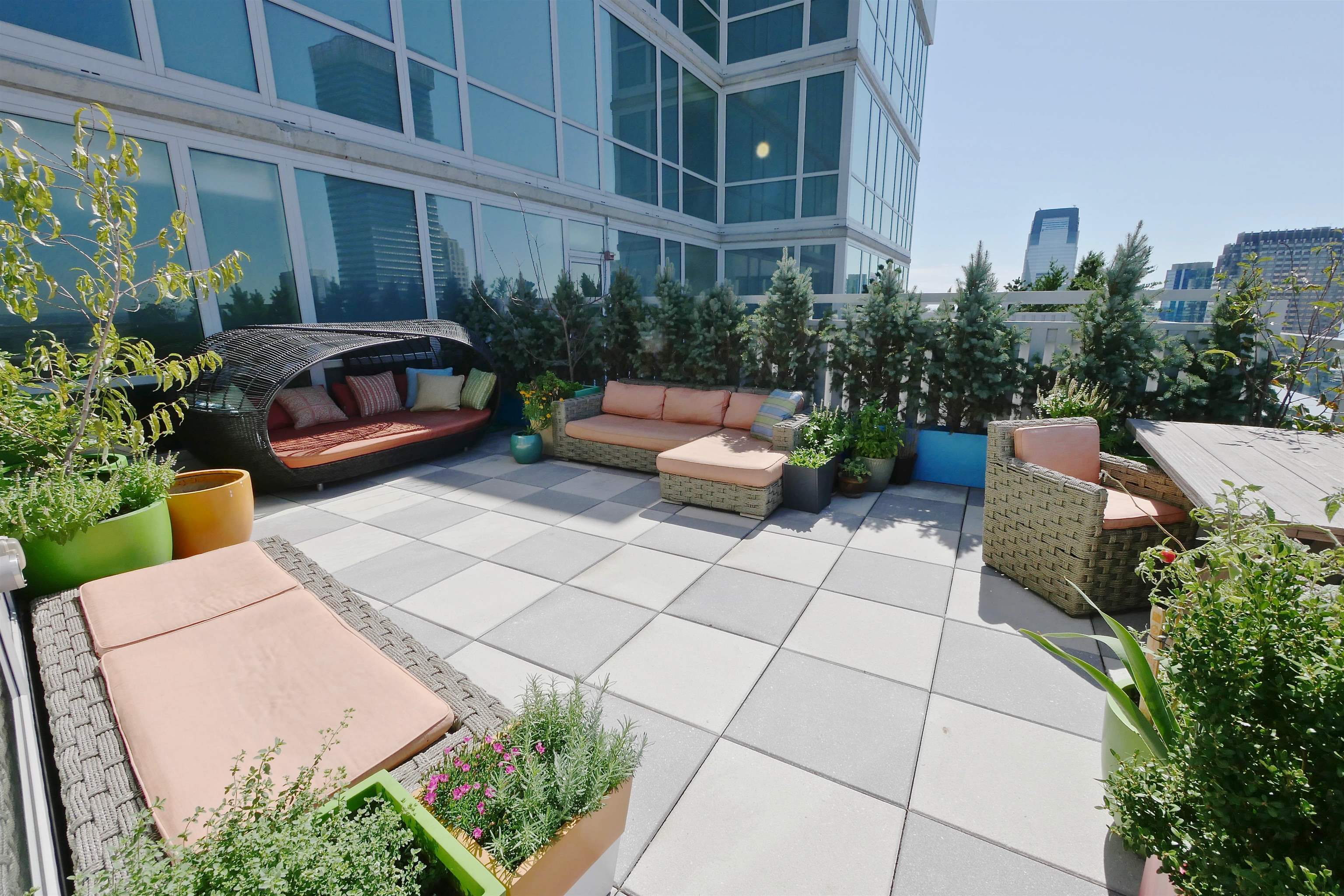 2 2nd Street, Unit 4001 Jersey City, NJ 07302 - Photo 10 of 31 a view of a patio with couches and potted plants