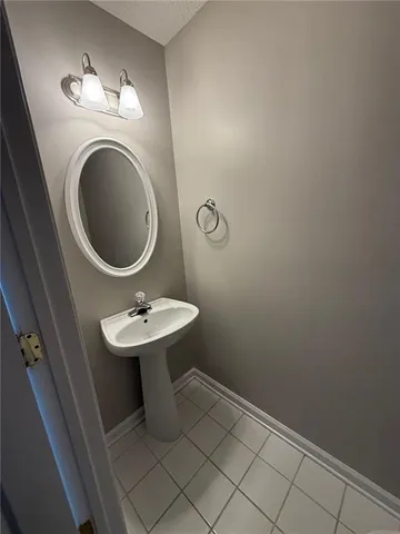 a bathroom with a sink a mirror and a toilet