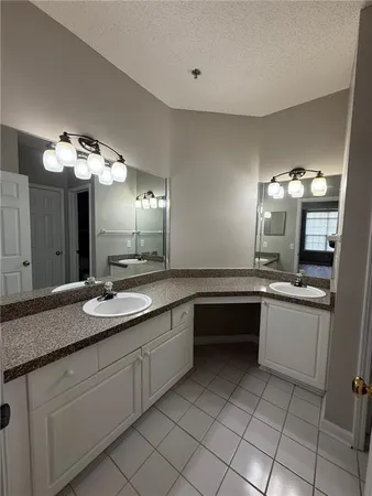a large kitchen with a sink and cabinets