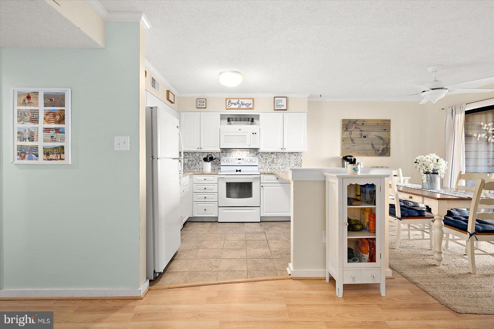 119 Old Landing Road, Unit 102A Ocean City, MD 21842 - Photo 16 of 47 a large white kitchen with stainless steel appliances