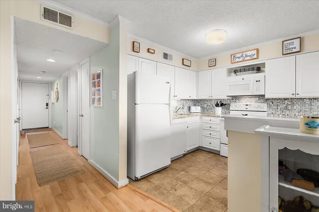 a kitchen with cabinets appliances and a sink