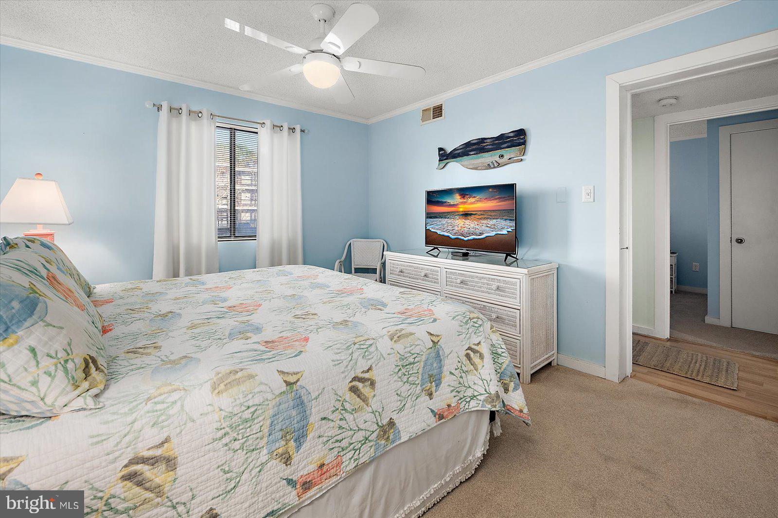 119 Old Landing Road, Unit 102A Ocean City, MD 21842 - Photo 24 of 47 a bedroom with a bed and a flat screen tv