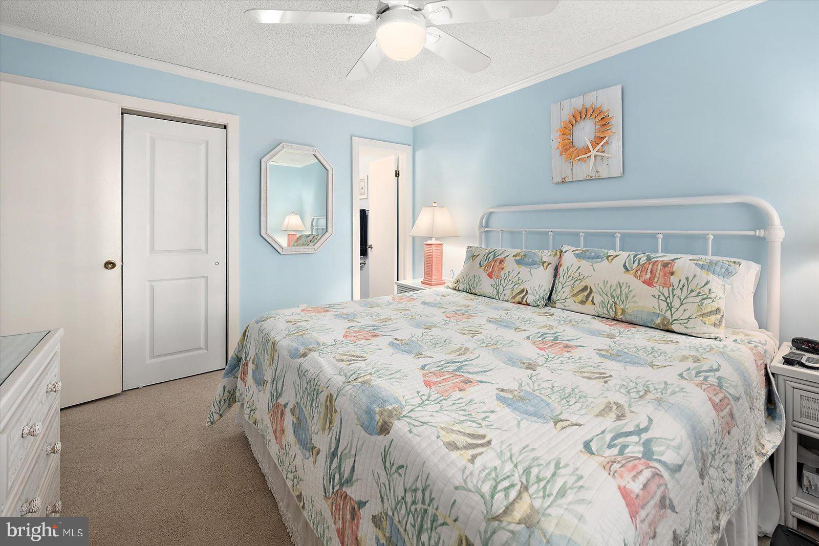 119 Old Landing Road, Unit 102A Ocean City, MD 21842 - Photo 25 of 47 a bedroom with a bed and a chandelier