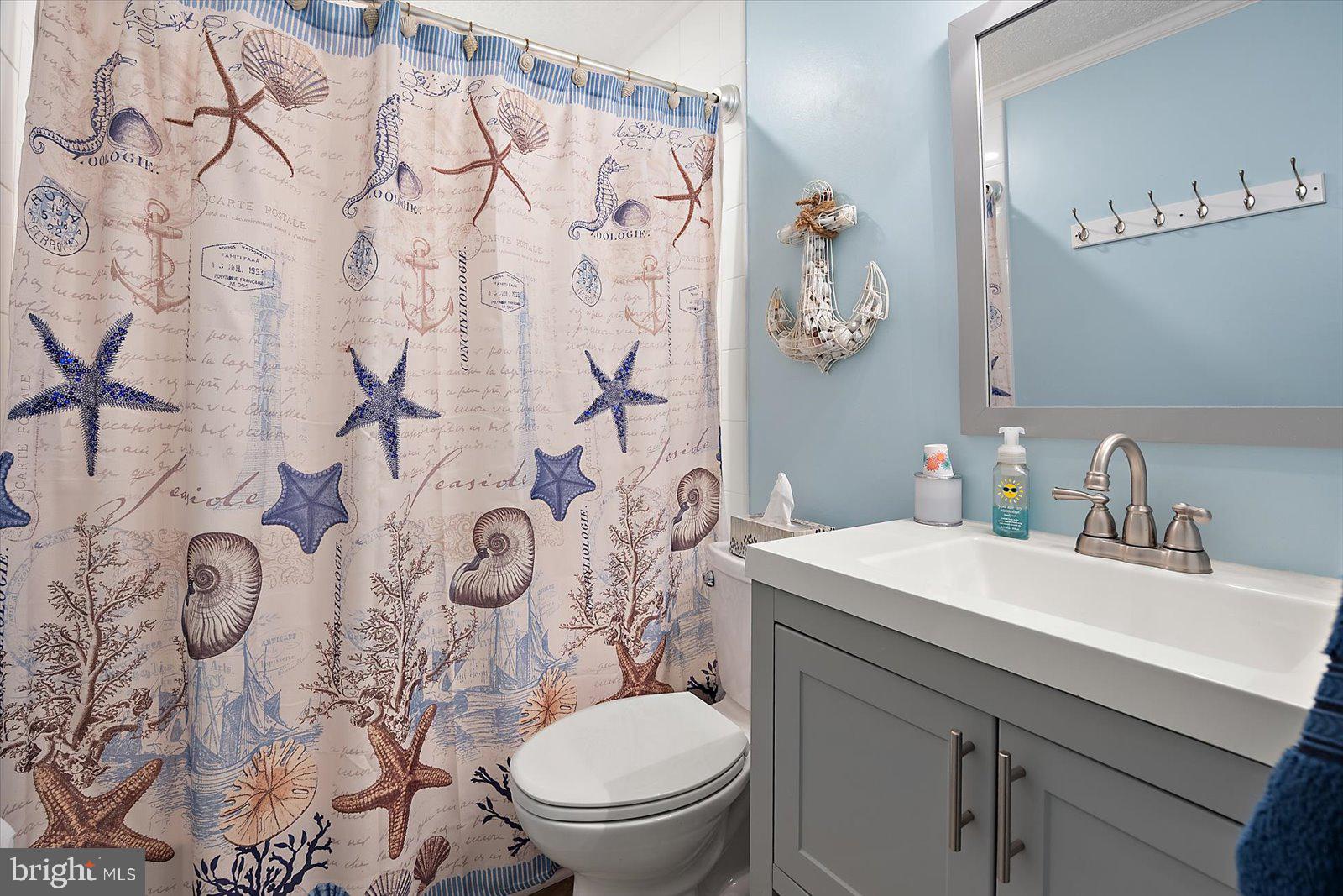 119 Old Landing Road, Unit 102A Ocean City, MD 21842 - Photo 30 of 47 a bathroom with a sink vanity mirror and toilet