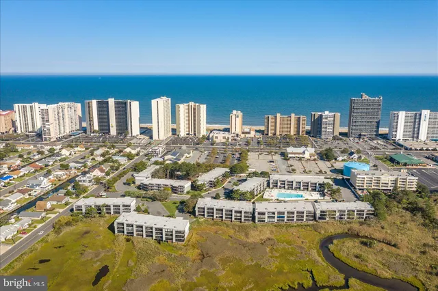 a balcony with wooden floor table and chairs