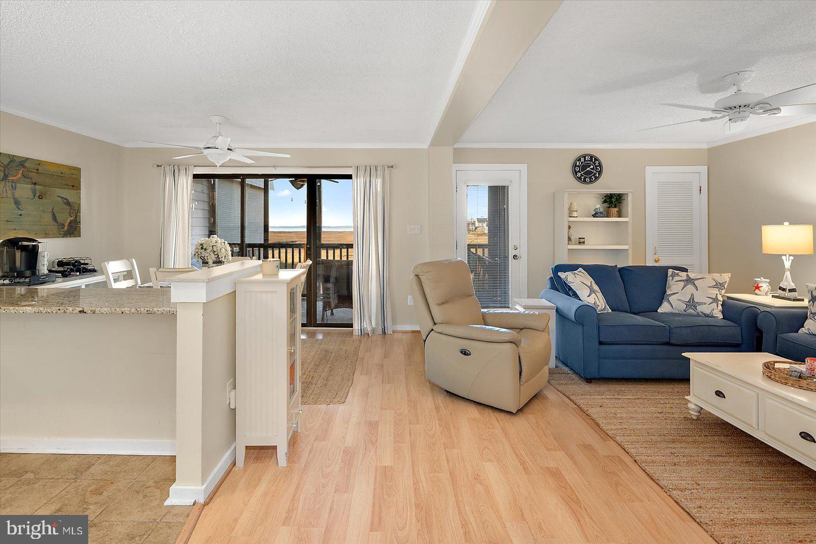 119 Old Landing Road, Unit 102A Ocean City, MD 21842 - Photo 4 of 47 a living room with furniture and a large window