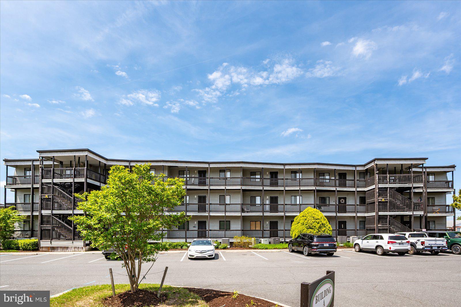 119 Old Landing Road, Unit 102A Ocean City, MD 21842 - Photo 43 of 47 a picture of a building with many windows and plants