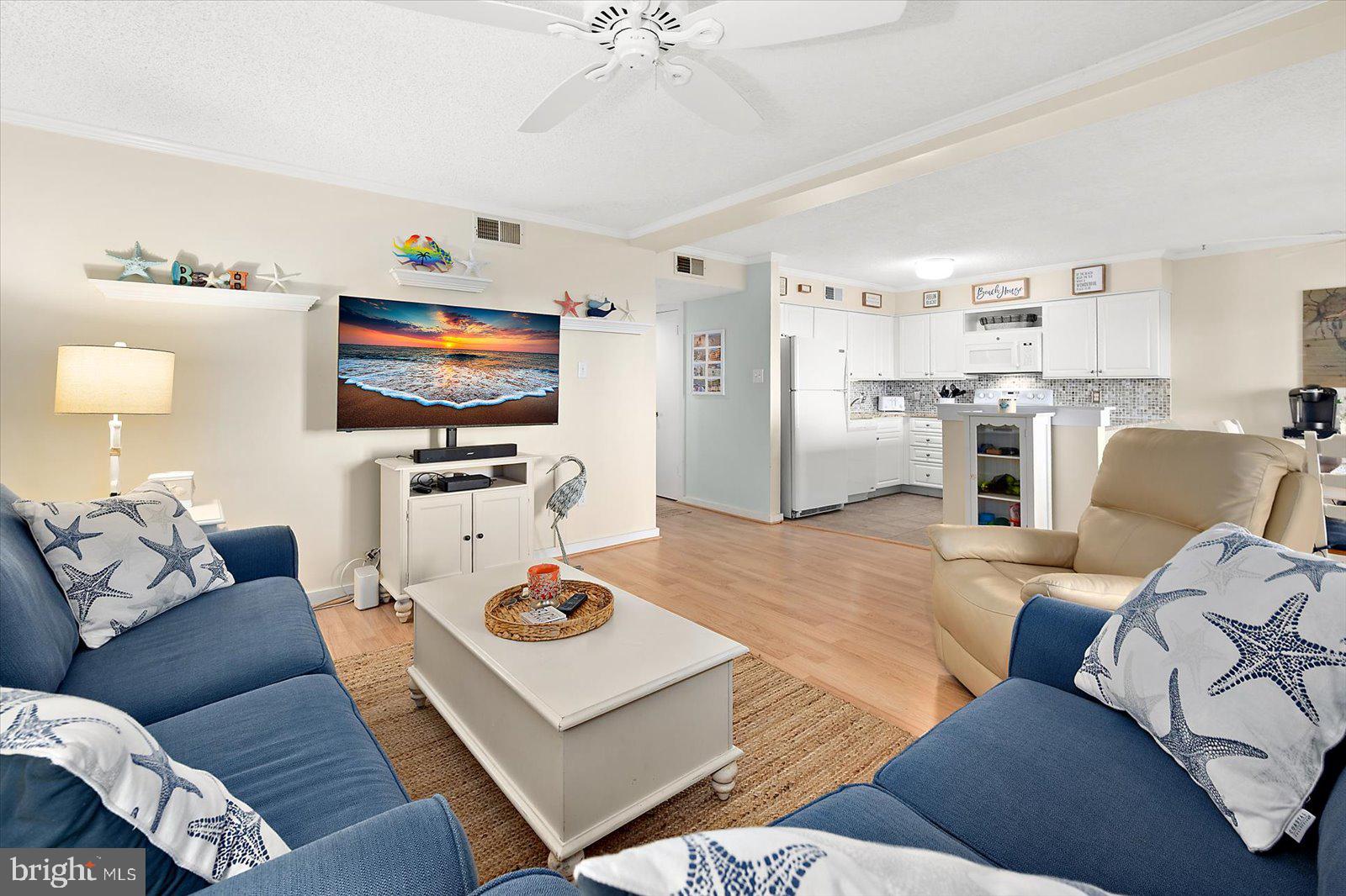 119 Old Landing Road, Unit 102A Ocean City, MD 21842 - Photo 5 of 47 a living room with furniture and a flat screen tv