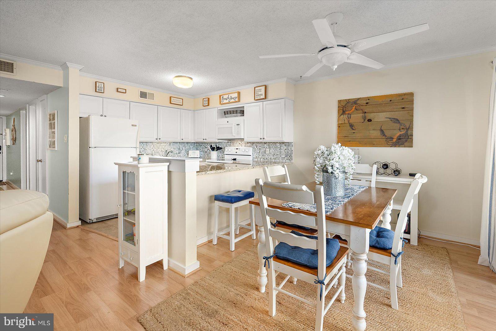 119 Old Landing Road, Unit 102A Ocean City, MD 21842 - Photo 7 of 47 a view of a dining room with furniture and wooden floor