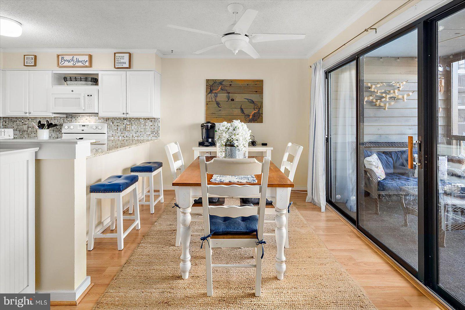 119 Old Landing Road, Unit 102A Ocean City, MD 21842 - Photo 8 of 47 a dining room with wooden floor and a rug