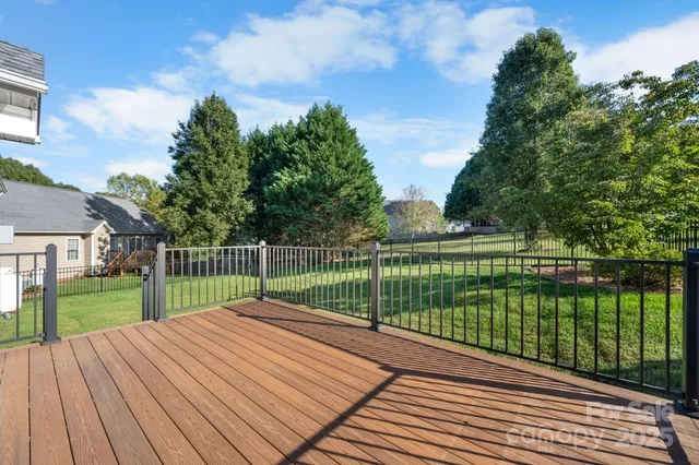 a view of a deck with a big yard