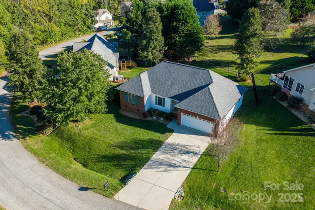 a aerial view of a house with a yard table and chairs