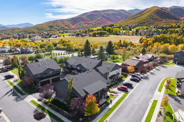 1141 520 West Midway, UT 84049 - Photo 37 of 40 Modern residential architecture with dark-toned siding and pitched roofs, surrounded by landscaped grounds and paved streets