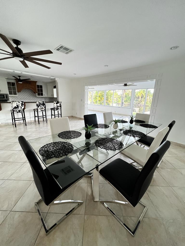 3324 Lakeview Boulevard Delray Beach, FL 33445 - Photo 7 of 36 a living room with stainless steel appliances kitchen island granite countertop a stove and a view of living room