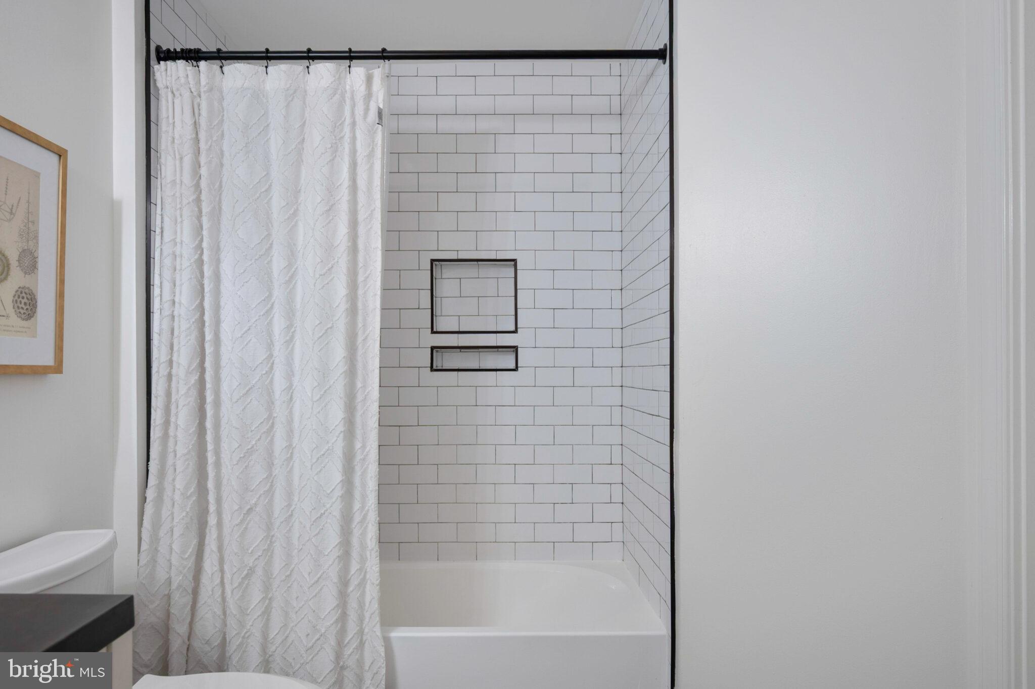 3650 South Glebe Road, Unit 450 Arlington, VA 22202 - Photo 19 of 60 a bathroom with a shower curtain and a toilet