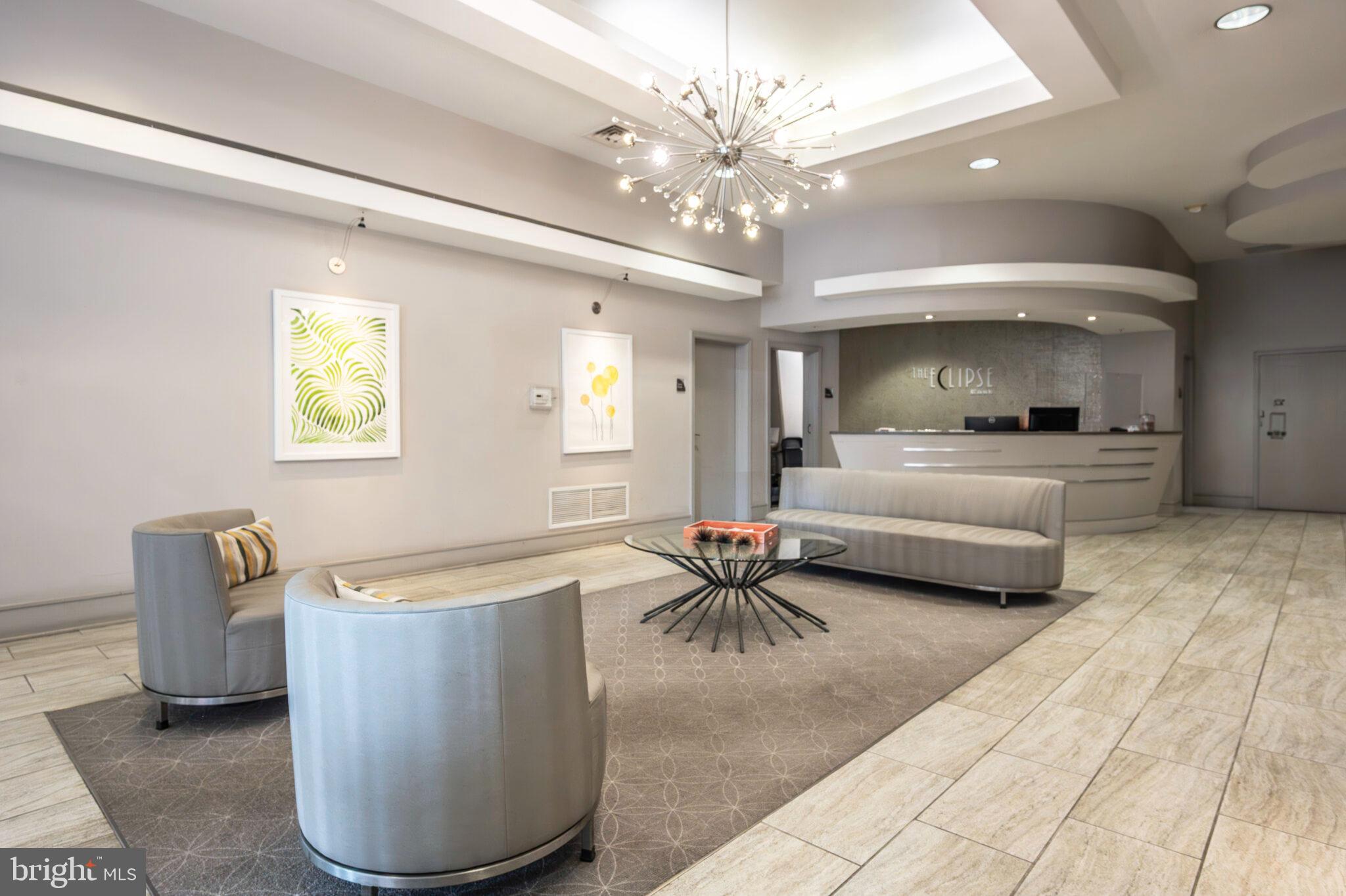 3650 South Glebe Road, Unit 450 Arlington, VA 22202 - Photo 30 of 60 a living room with furniture a chandelier and a dining table
