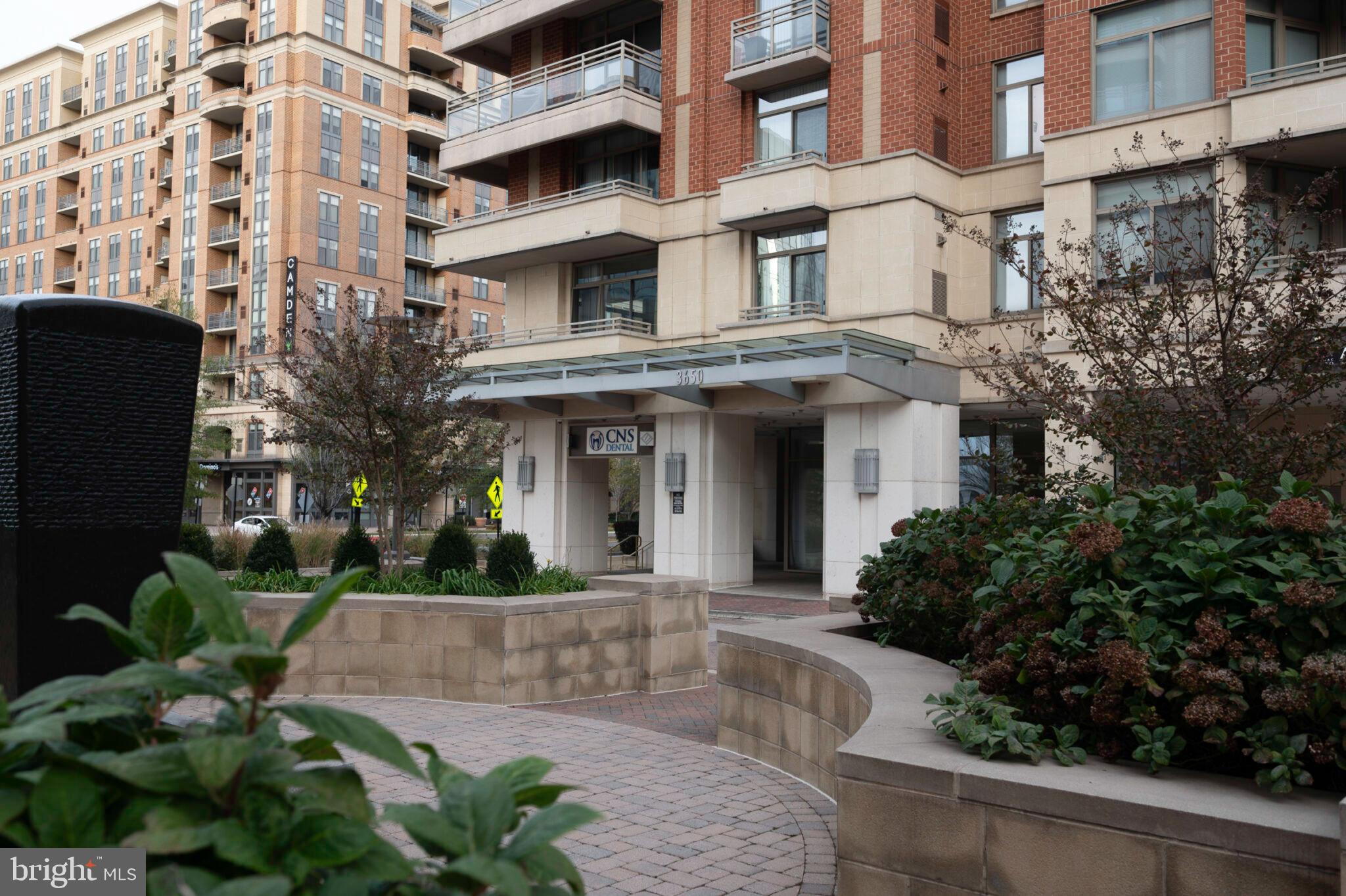 3650 South Glebe Road, Unit 450 Arlington, VA 22202 - Photo 4 of 60 a front view of a multi story building with a yard