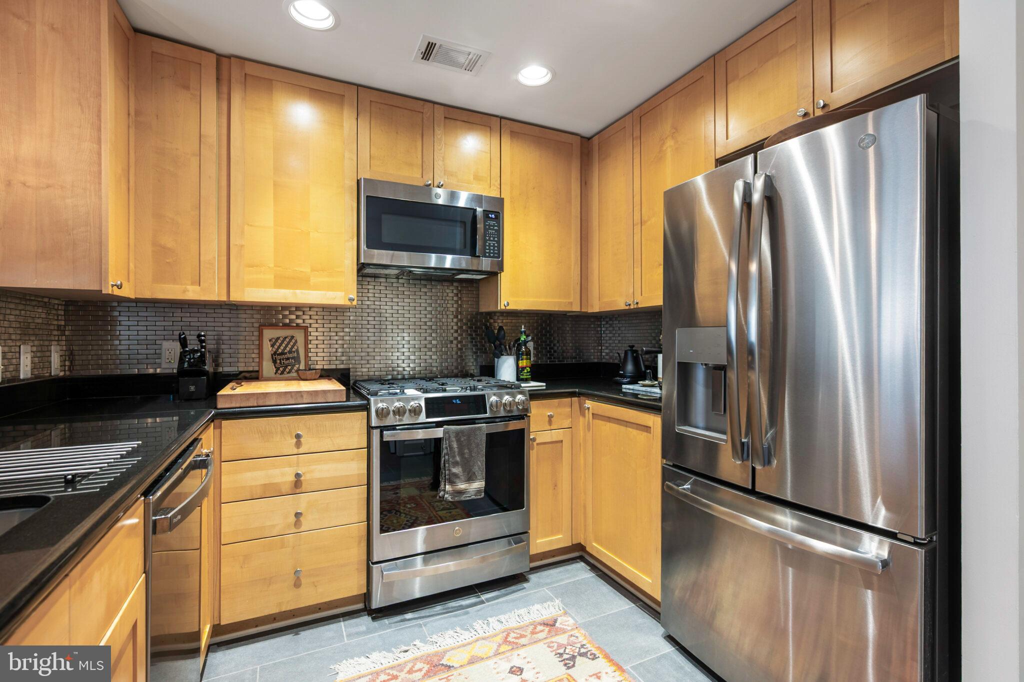 3650 South Glebe Road, Unit 450 Arlington, VA 22202 - Photo 7 of 60 a kitchen with stainless steel appliances granite countertop a refrigerator stove and sink