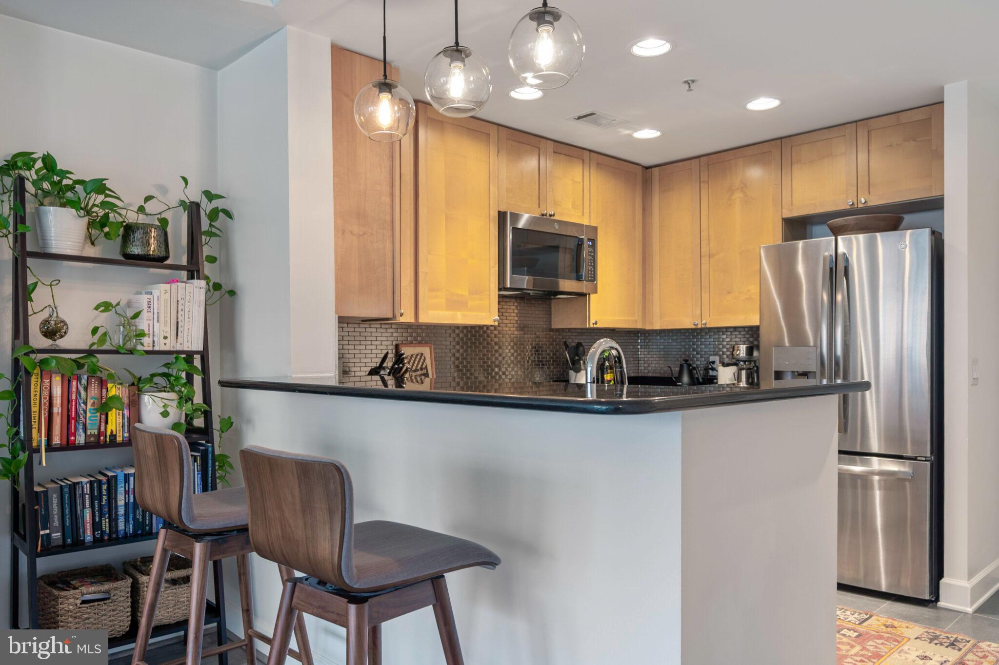 3650 South Glebe Road, Unit 450 Arlington, VA 22202 - Photo 8 of 60 a kitchen with stainless steel appliances granite countertop a refrigerator a stove top oven a sink and cabinets