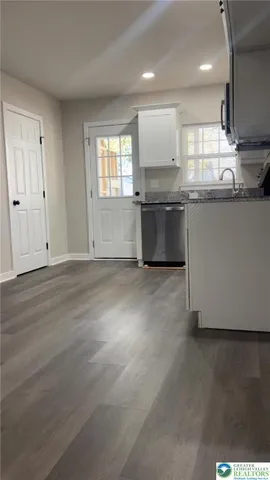 a kitchen with stainless steel appliances granite countertop a sink and a stove top oven