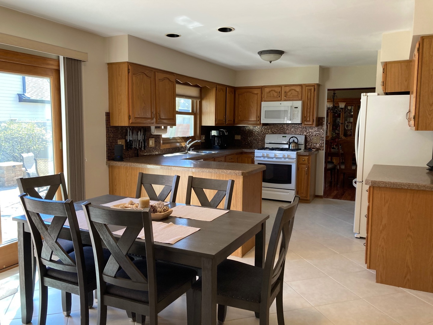 36 Redstart Road Naperville, IL 60565 - Photo 12 of 38 a dining table and chairs in a kitchen