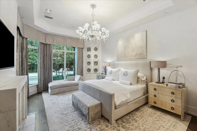 a bedroom with a bed and a chandelier
