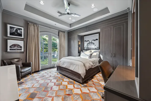 a bed sitting in a spacious bedroom next to a window