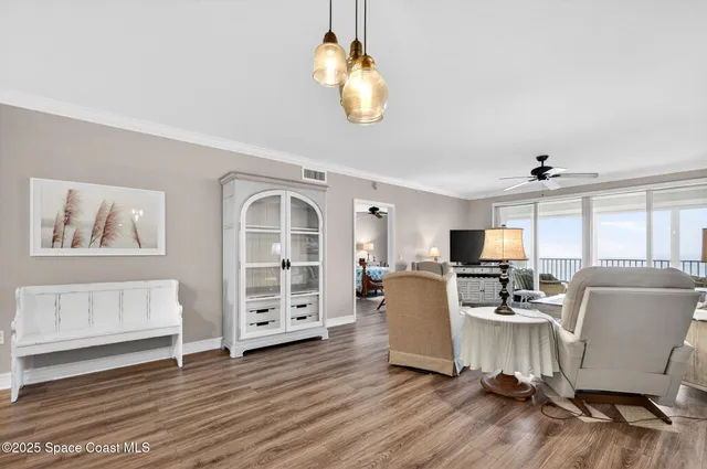 a view of a hallway with wooden floor and a cabinet