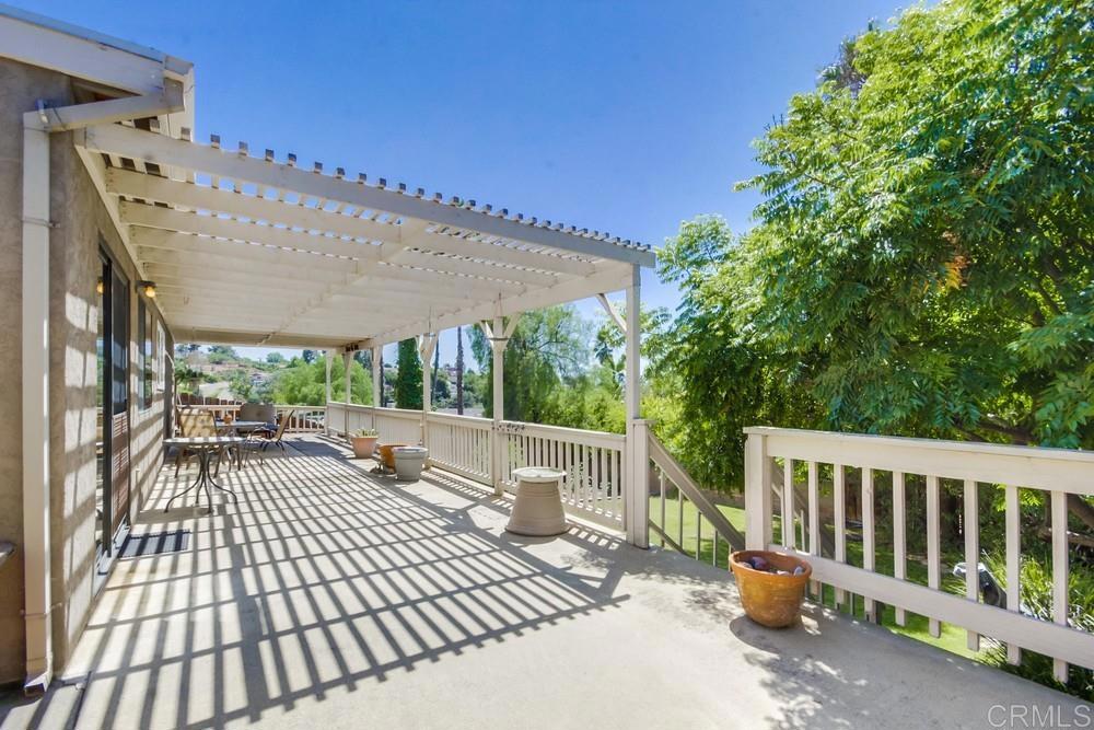 7932 Shalamar Drive El Cajon, CA 92021 - Photo 16 of 22 a view of a patio with a table and chairs under an umbrella