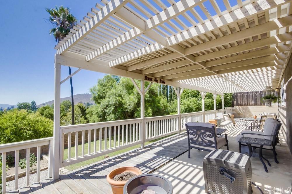 7932 Shalamar Drive El Cajon, CA 92021 - Photo 17 of 22 a view of a patio with a table chairs and a backyard