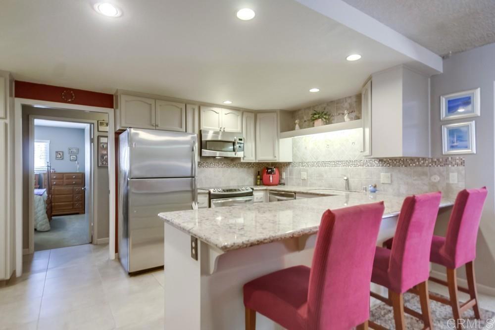 7932 Shalamar Drive El Cajon, CA 92021 - Photo 2 of 22 a kitchen with refrigerator and cabinets