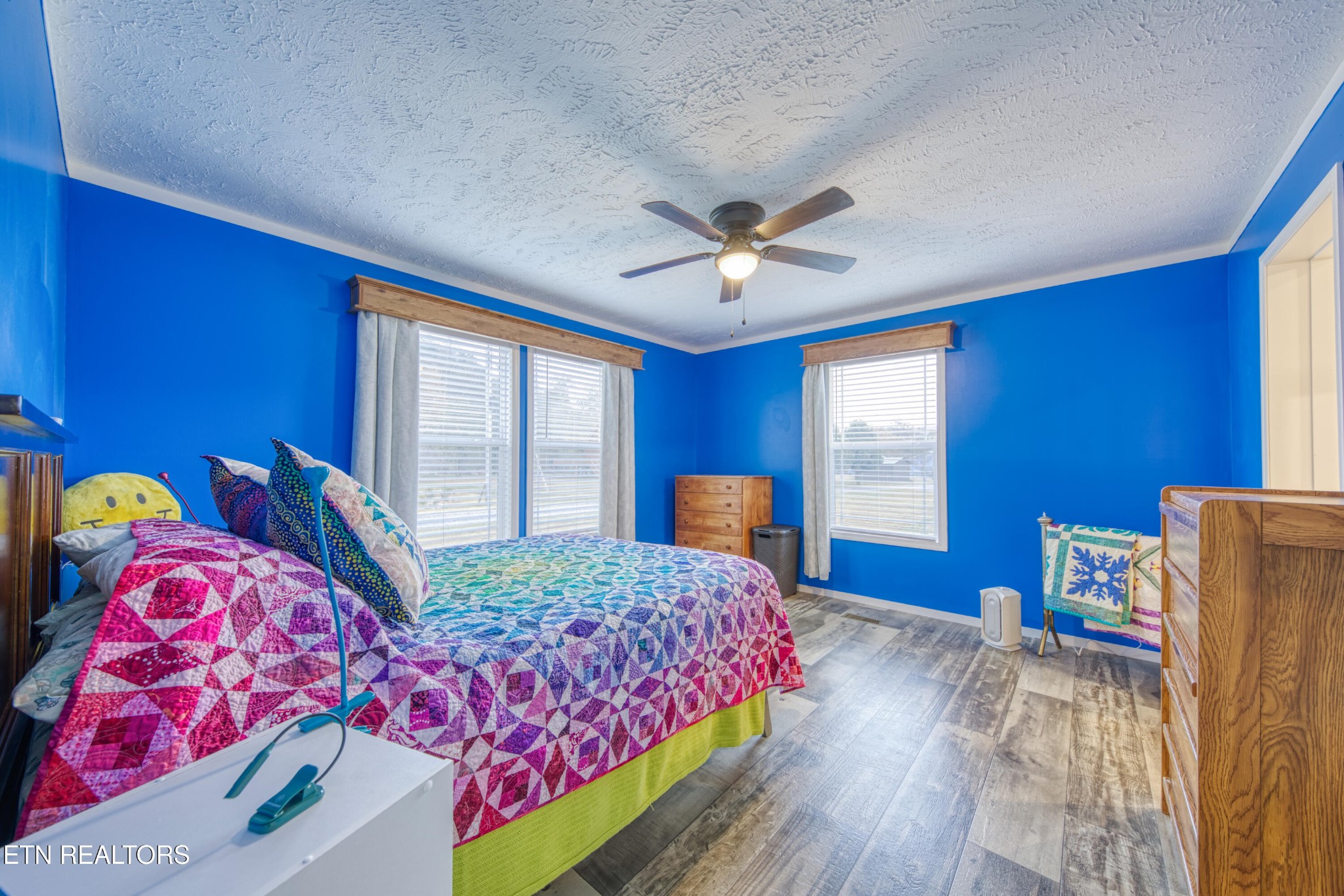3143 Webbing Way Cosby, TN 37722 - Photo 10 of 31 a bedroom with a bed and a chandelier
