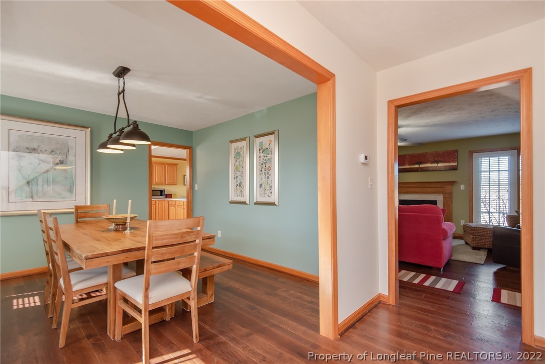 428 Rob Road Stedman, NC 28391 - Photo 11 of 45 a dining room with furniture wooden floor a chandelier