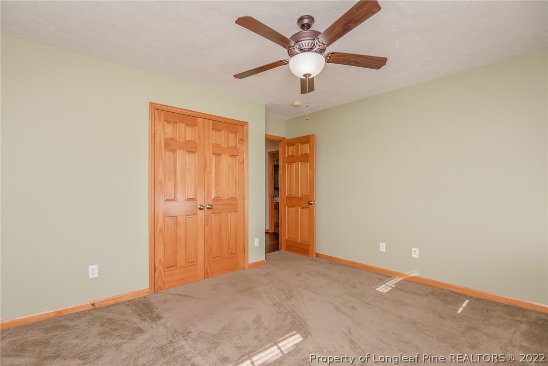 428 Rob Road Stedman, NC 28391 - Photo 28 of 45 an empty room with closet and a chandelier fan