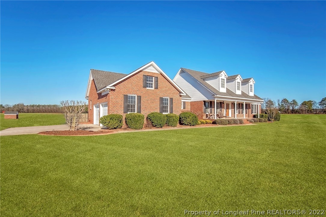 428 Rob Road Stedman, NC 28391 - Photo 3 of 45 a front view of a house with a garden and deck
