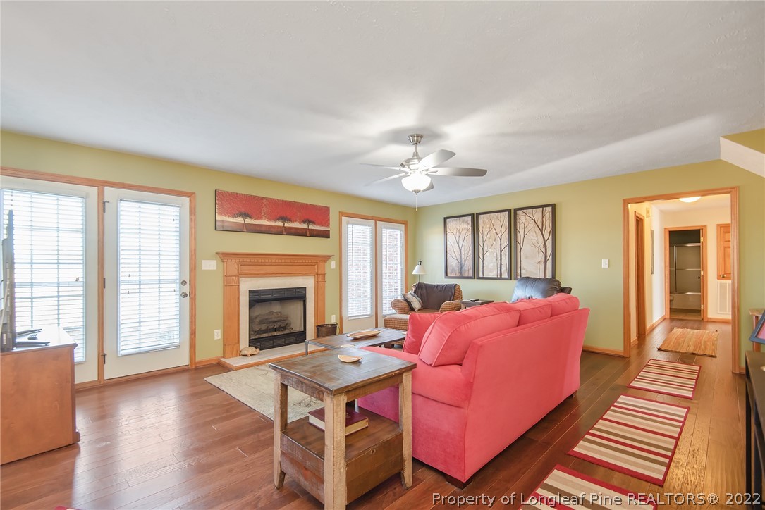 428 Rob Road Stedman, NC 28391 - Photo 7 of 45 a living room with furniture a fireplace and large windows