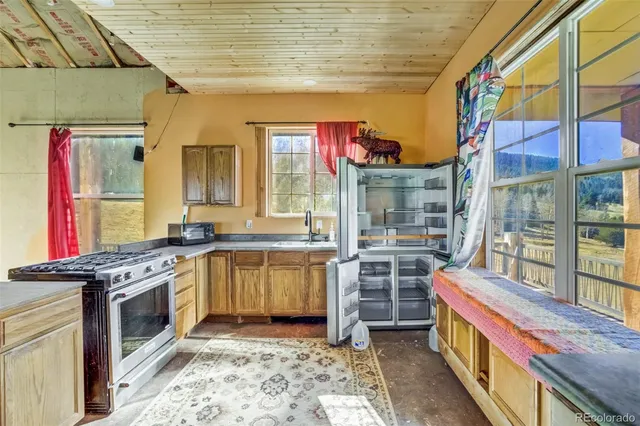 a kitchen with stainless steel appliances granite countertop a stove and cabinets