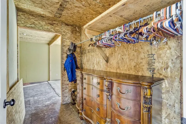 a view of walk in closet with clothes