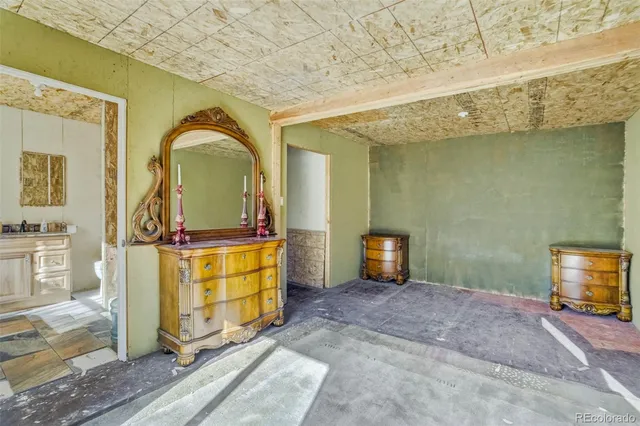a view of a livingroom with furniture and mirror