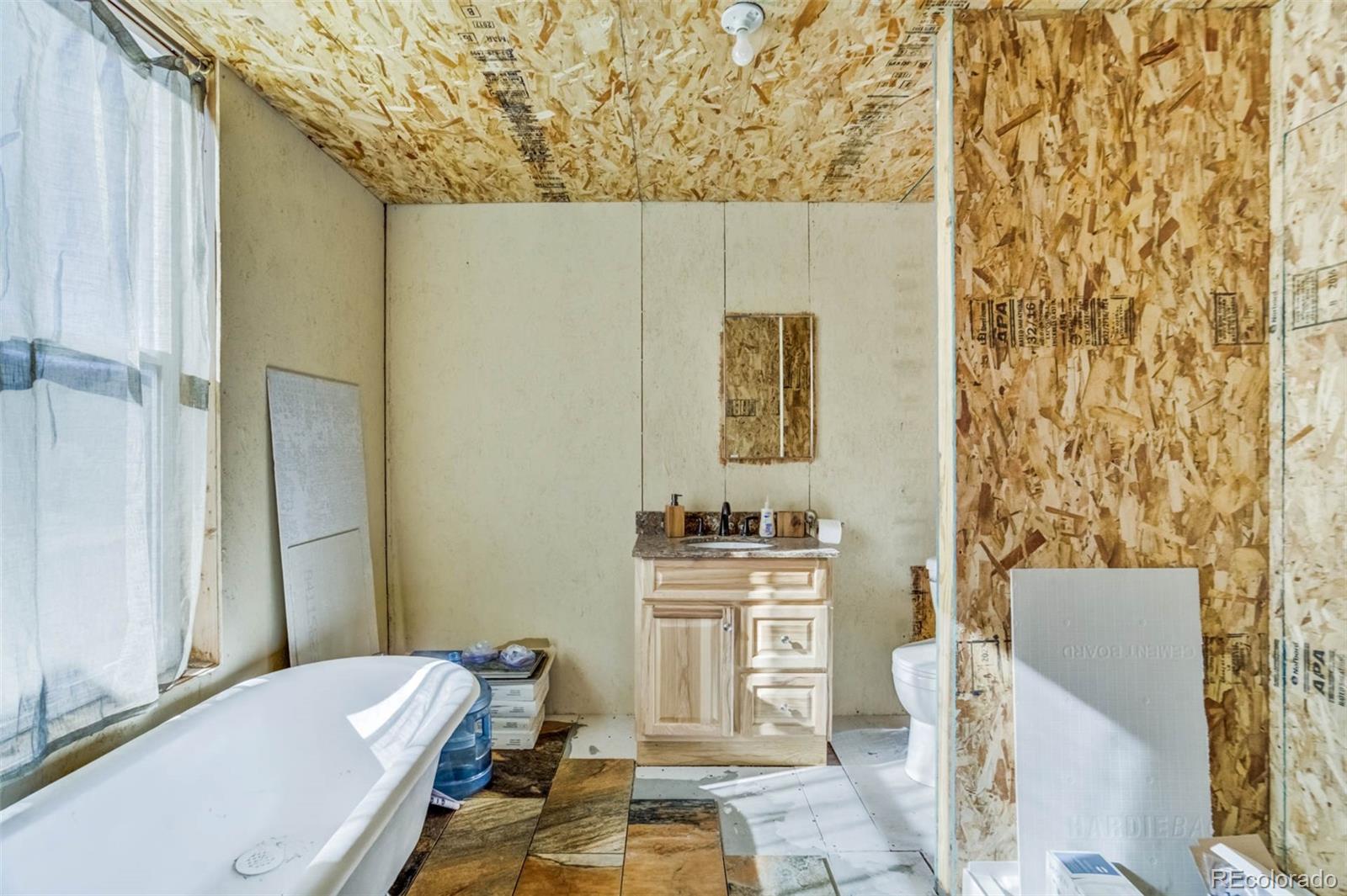 1440 North Range Road Guffey, CO 80820 - Photo 20 of 50 a bathroom with a sink toilet and shower