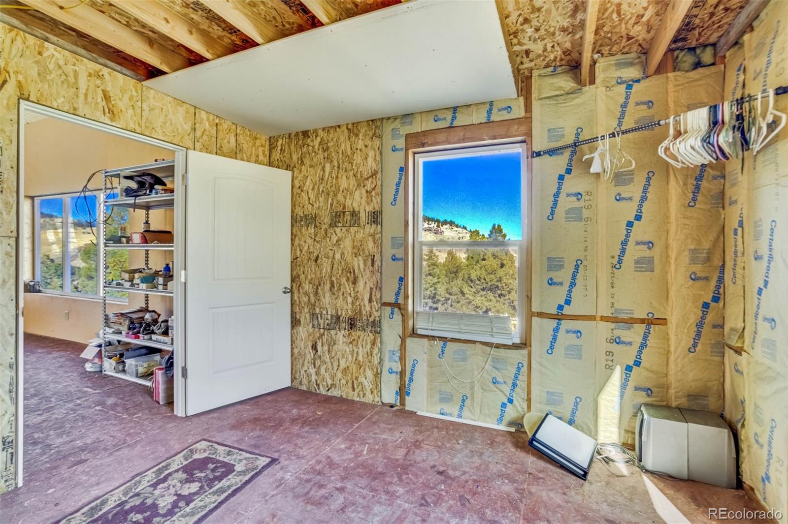 1440 North Range Road Guffey, CO 80820 - Photo 23 of 50 a view of walk in closet with clothes and shoes