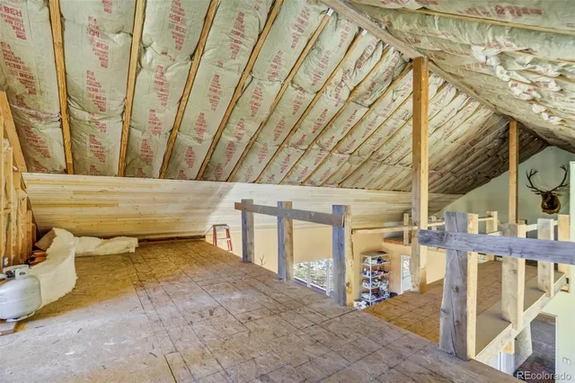 a view of a livingroom with furniture and staircase
