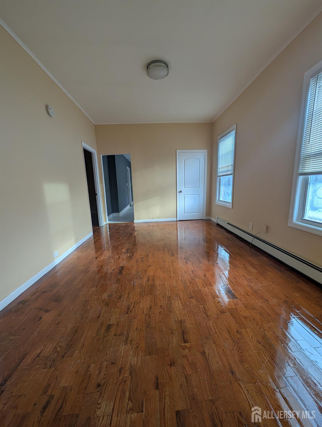 a view of a livingroom with wooden floor and a window