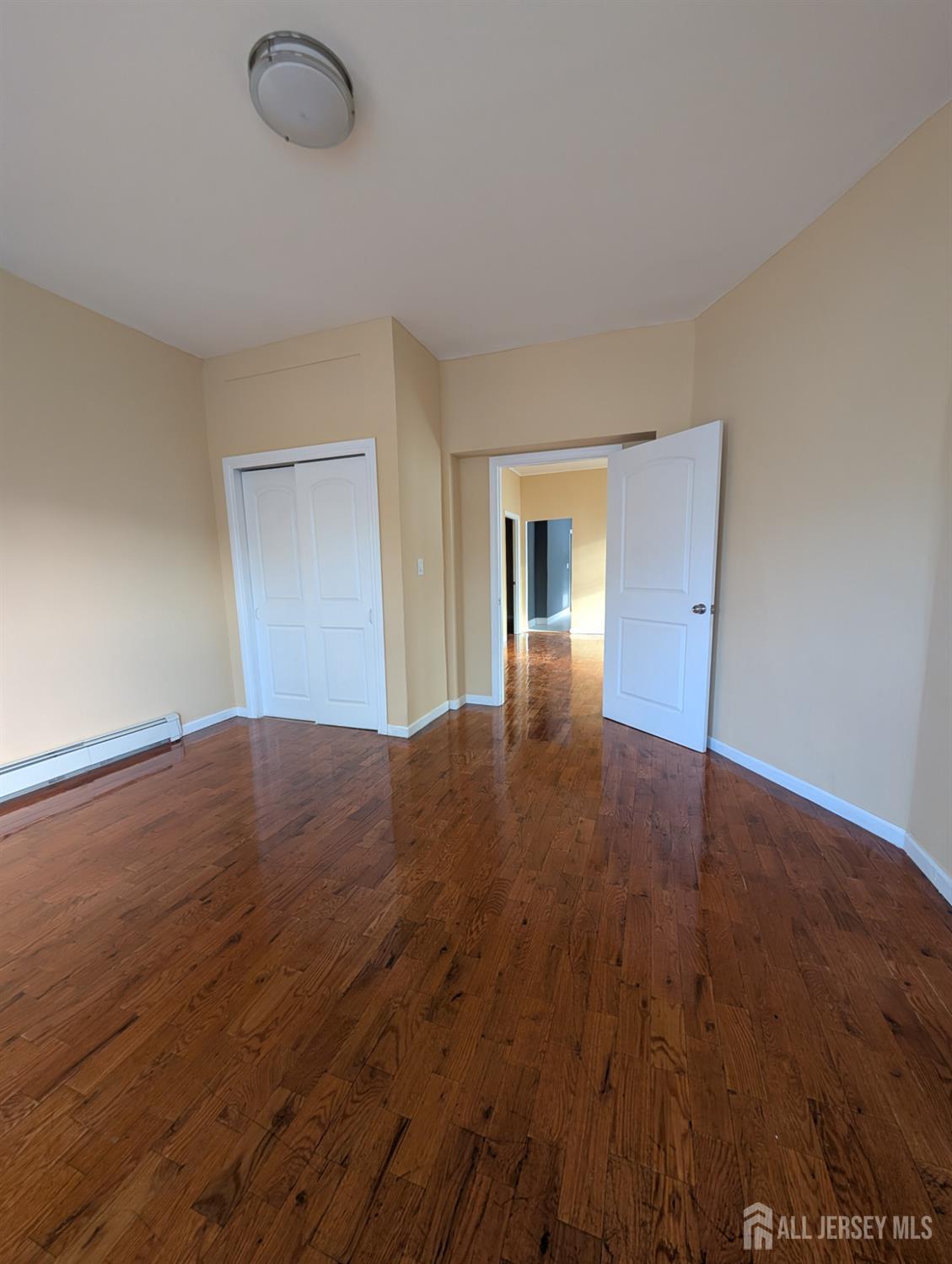 5 North 7th Street Newark, NJ 07107 - Photo 5 of 8 a view of empty room with wooden floor