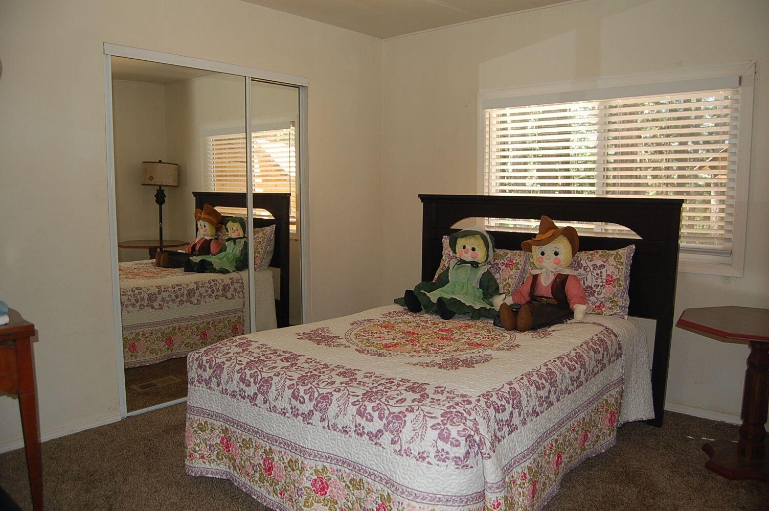 350 Hamilton Avenue Cave Junction, OR 97523 - Photo 16 of 23 a bedroom with a bed and a dresser in it