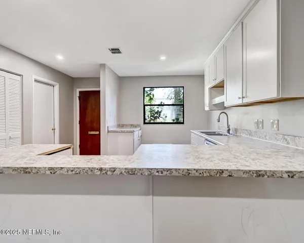 a kitchen with stainless steel appliances granite countertop sink refrigerator and stove