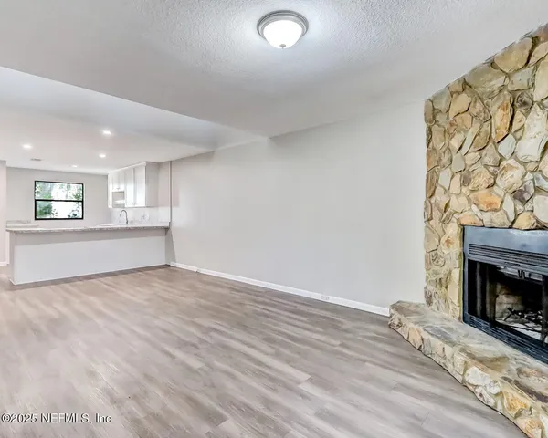 a view of an empty room and a fireplace